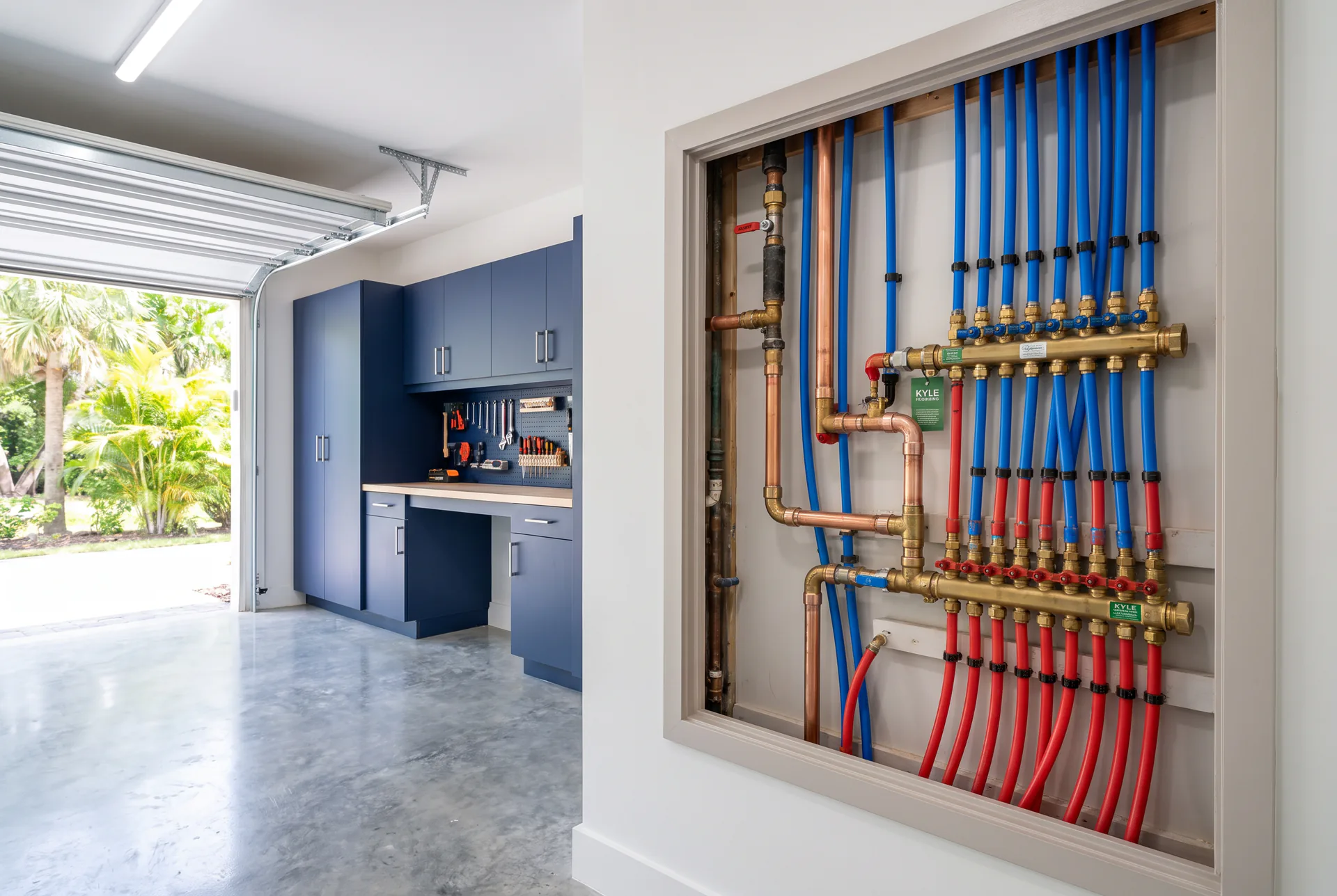 A completed whole-home repipe: labeled PEX manifolds with Kyle Plumbing service tags, ready for inspection